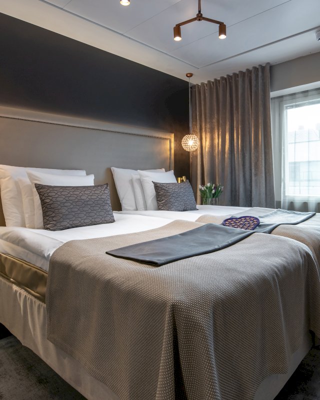 Hotellihuone ja sänky Seurahuone Lofts -hotellissa